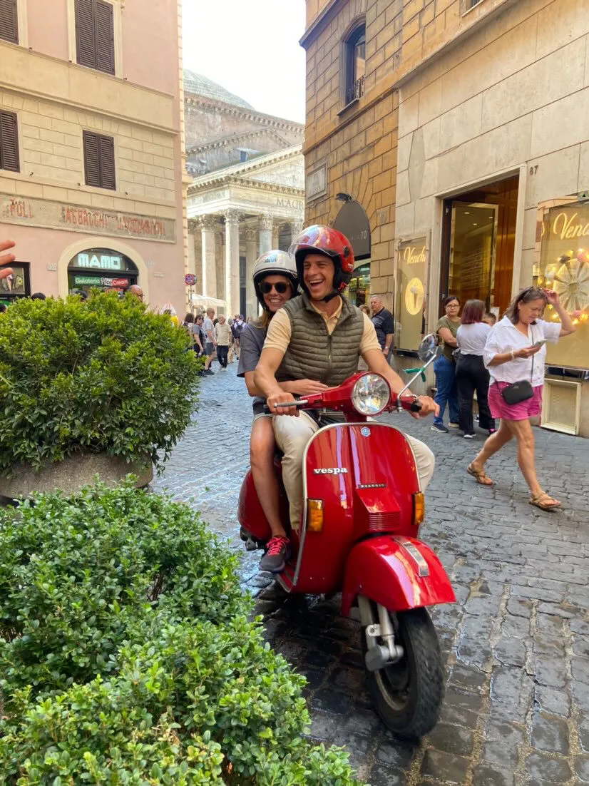 Guest on a red Vespa in front of the Pantheon