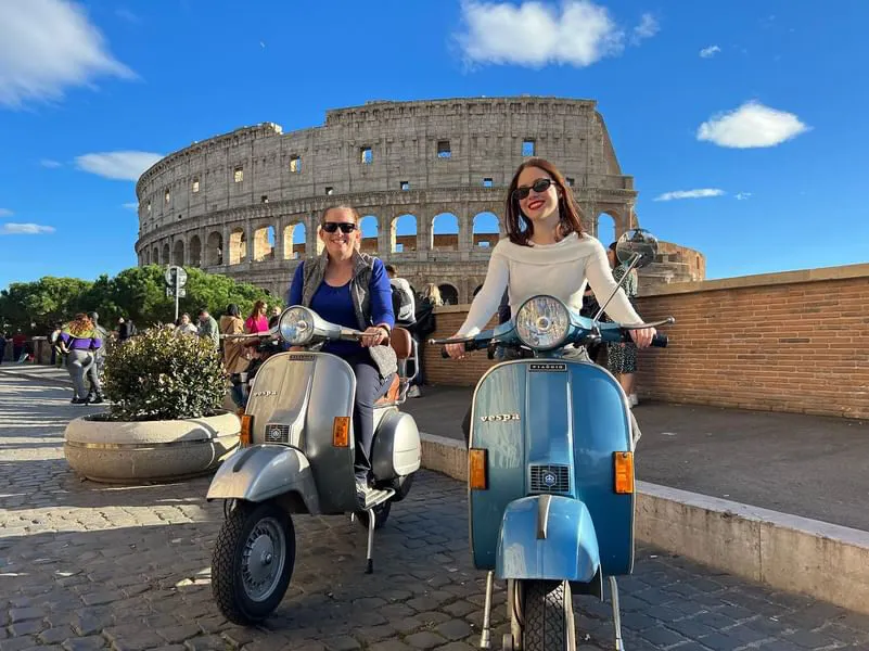 Group on Vespas in front of the Colosseum