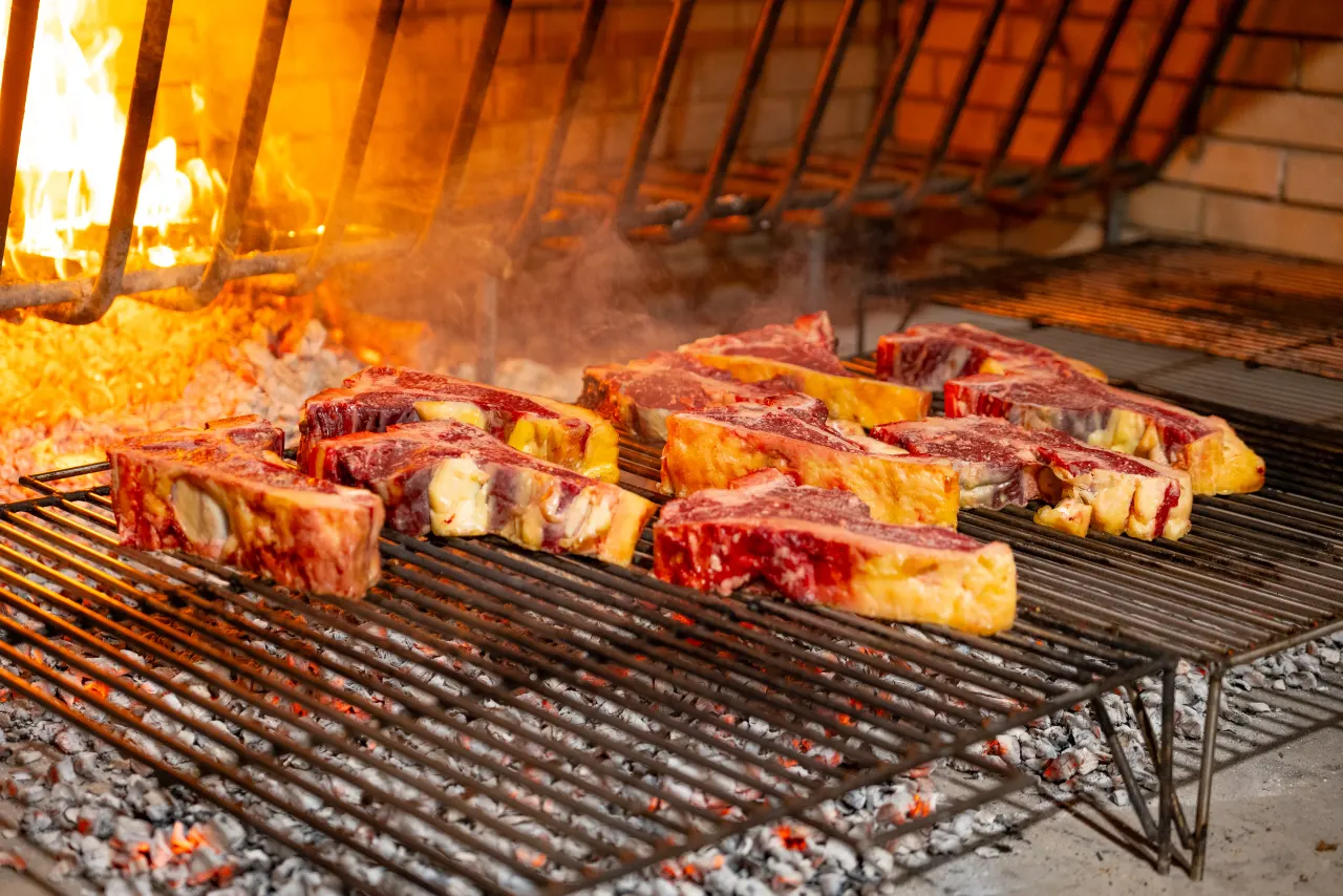 Steaks on the grill amid the flames