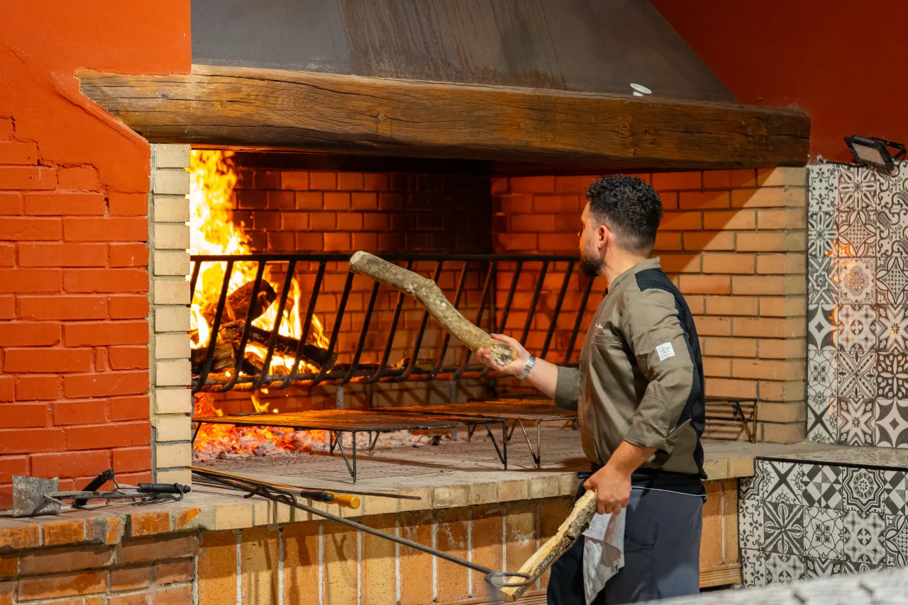 Preparing the embers before cooking