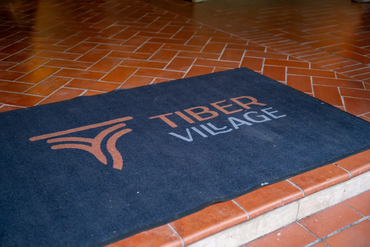 Entrance of Tiber Village with the logo, set up for the event